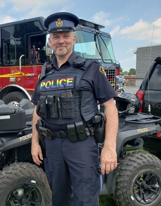 An OPP police officer with the text "police" in a rainbow